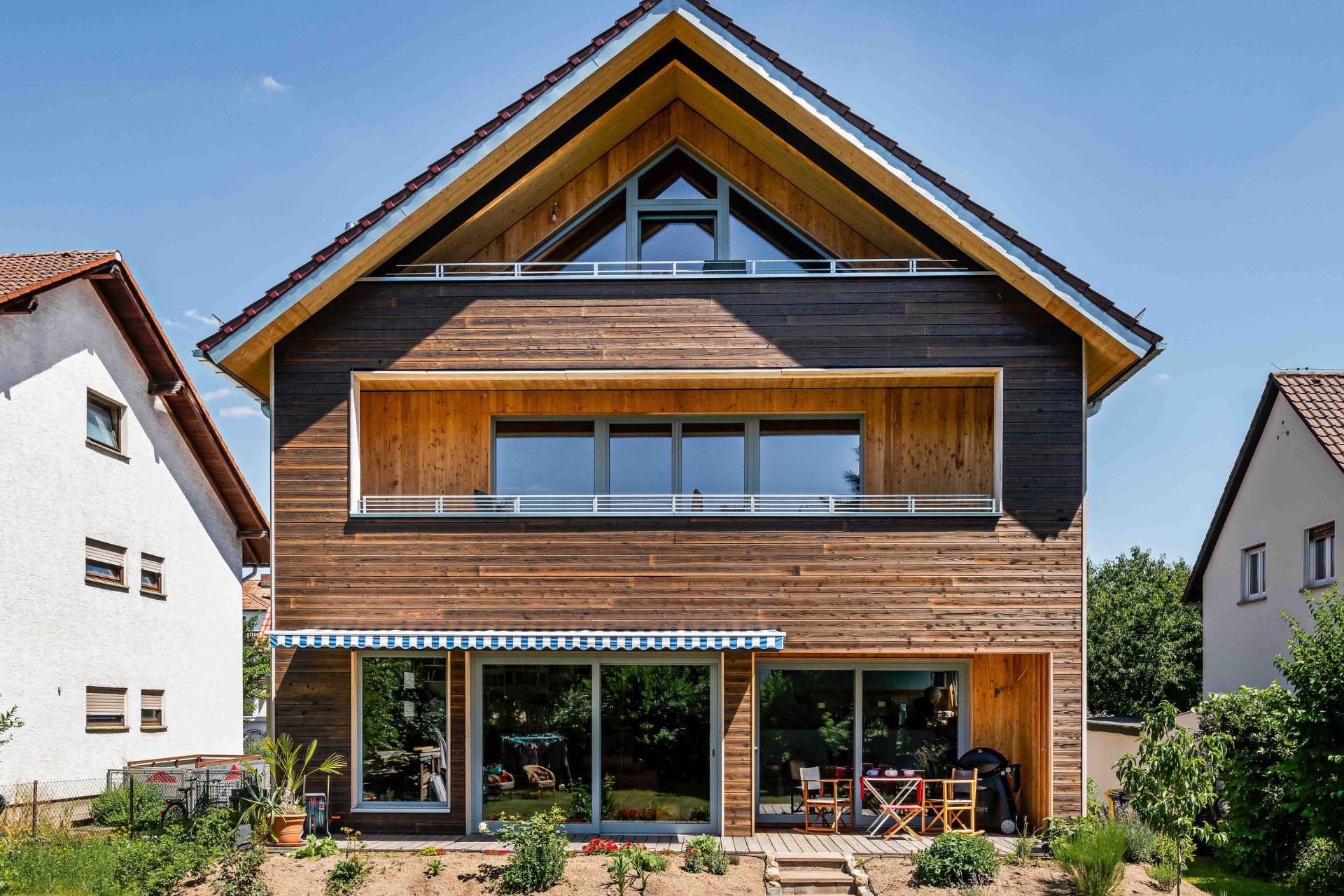 Maison avec façade en bois brun clair et toit pointu